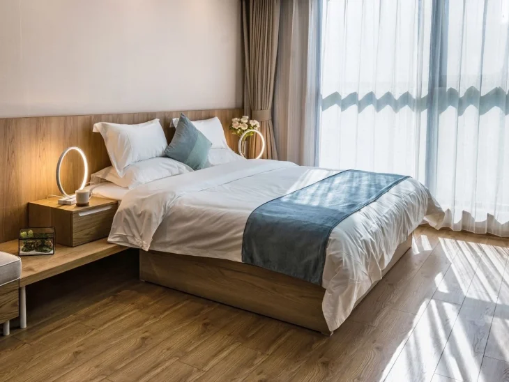 Cozy bedroom with warm ambient lighting and natural sunlight