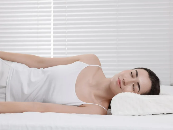 Woman Sleeping on Orthopedic Pillow at Home